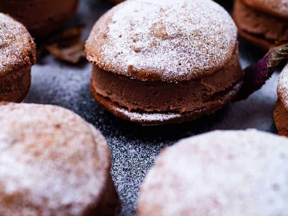 Chocolate Mascarpone Sandwich Cookies with sugar dusting.