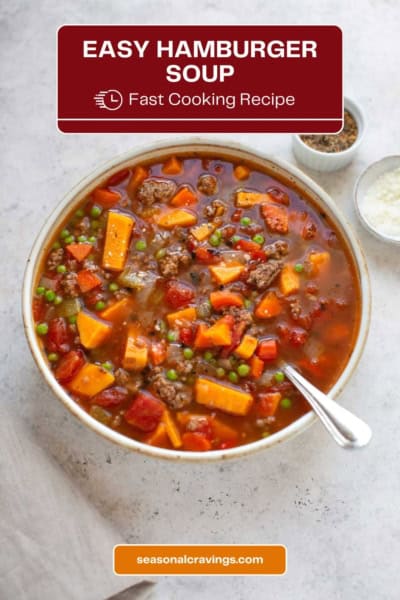 A bowl of hearty hamburger soup filled with vegetables and ground meat is placed on a light surface with a spoon. The overlay text reads "Easy Hamburger Soup: Fast Cooking Recipe" and "seasonalcravinging.com.