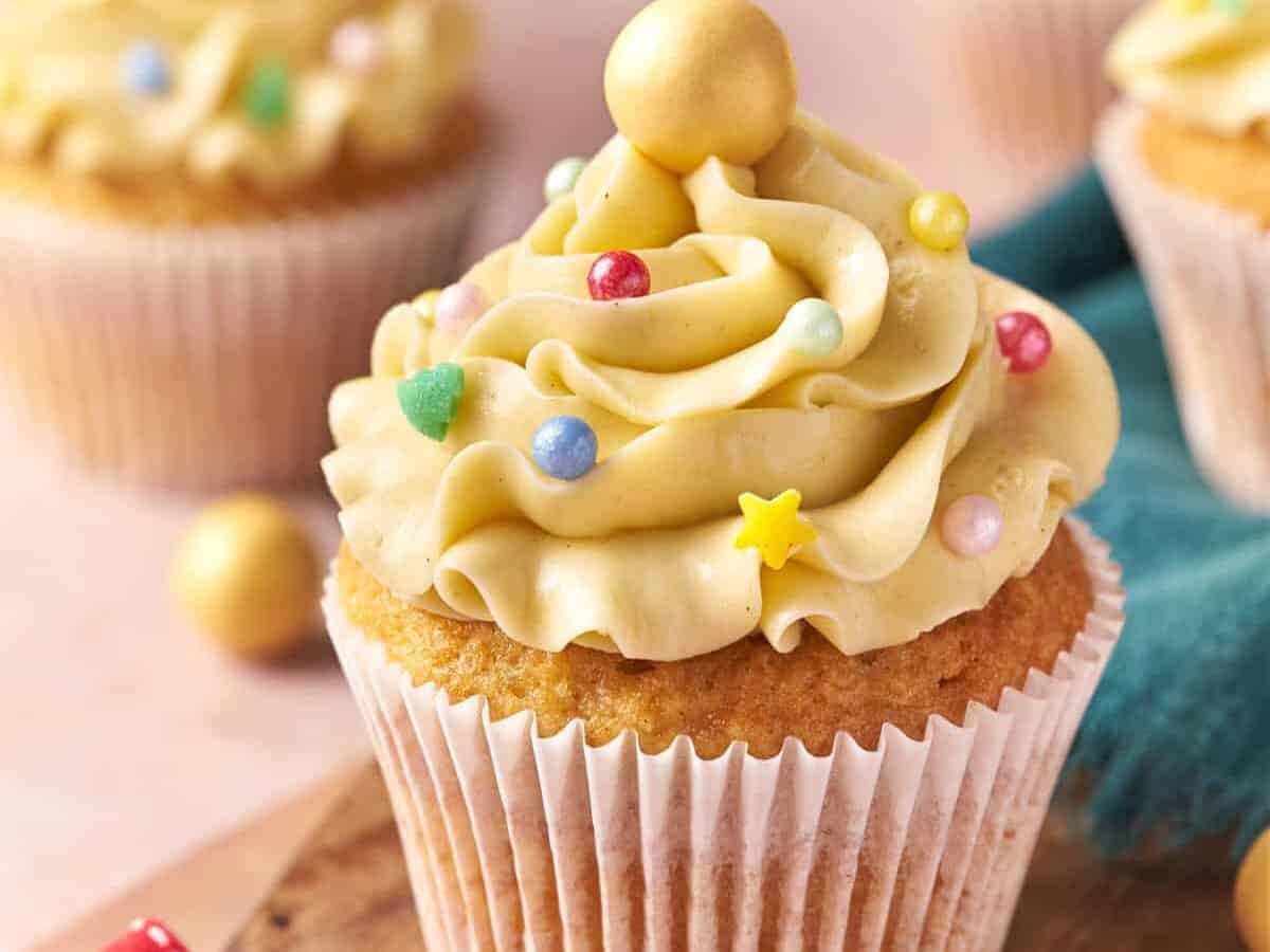 Eggnog cupcakes with frosting and holiday decors.