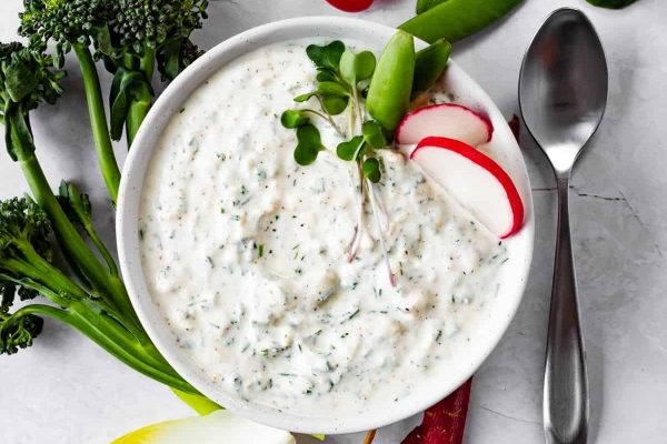 A bowl of dip with radishes and radishes.