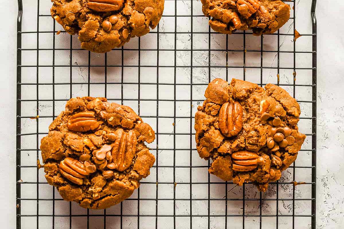 Pecan cookies on a cooling rack.