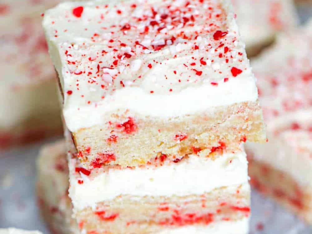 Peppermint Sugar Cookie Bars stacked on top of each other.