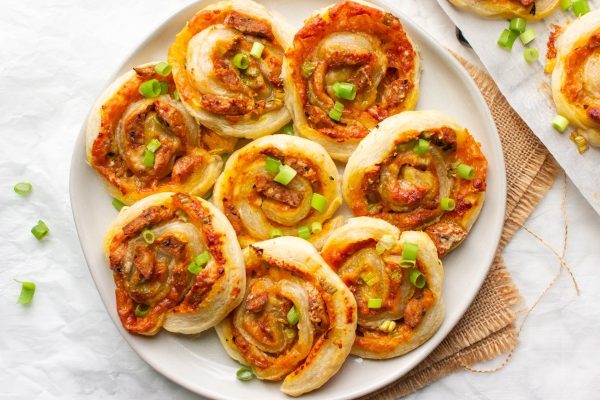 Cheesy meatball pizza rolls on a plate.