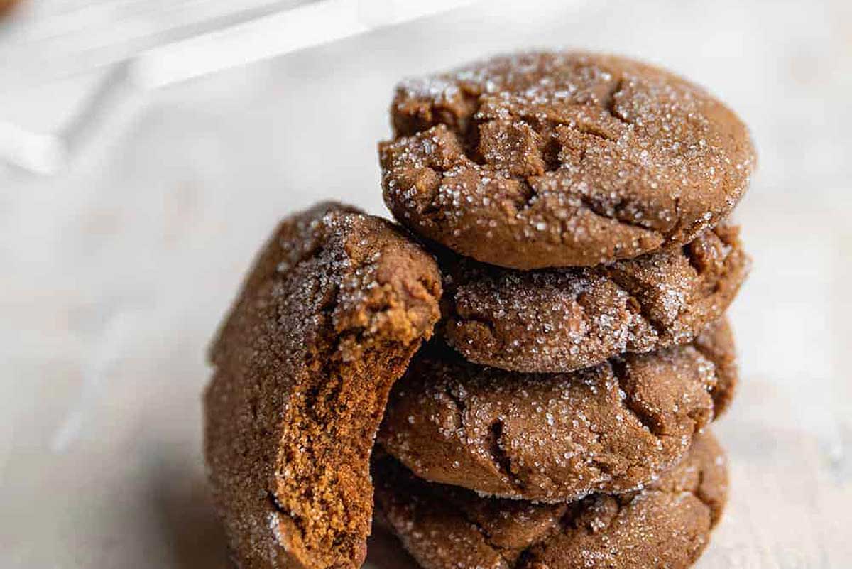 A stack of sugar cookies on a wooden table.