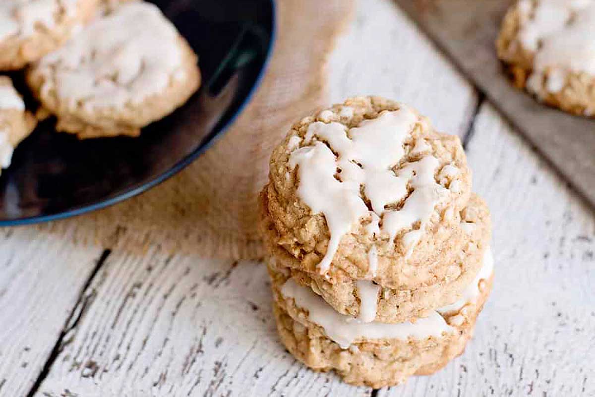 A stack of oatmeal cookies with icing on top.