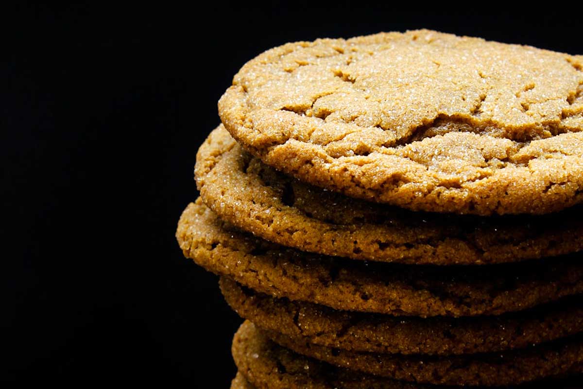 A stack of ginger cookies on a black background.