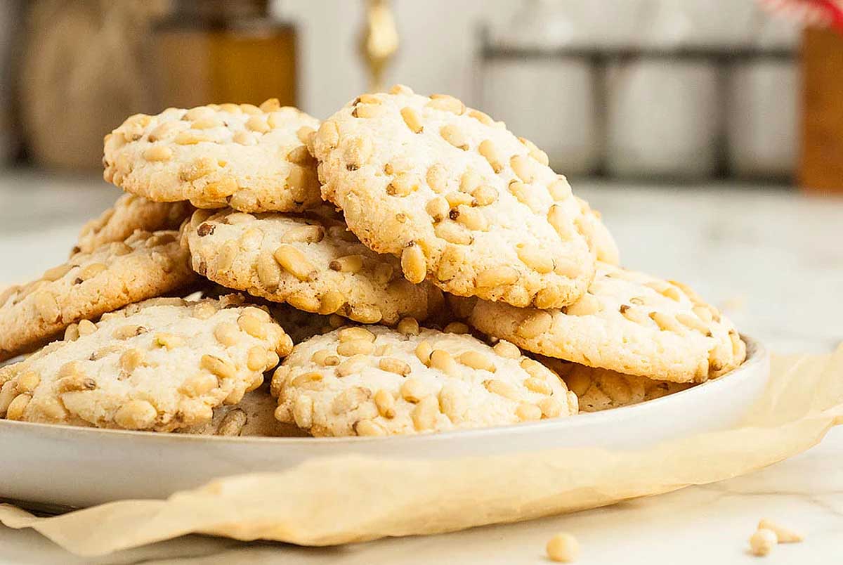 A pile of cookies on a white plate.