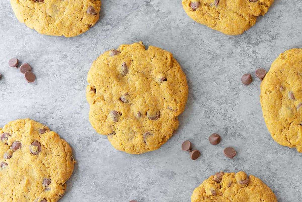 Pumpkin chocolate chip cookies on a baking sheet.