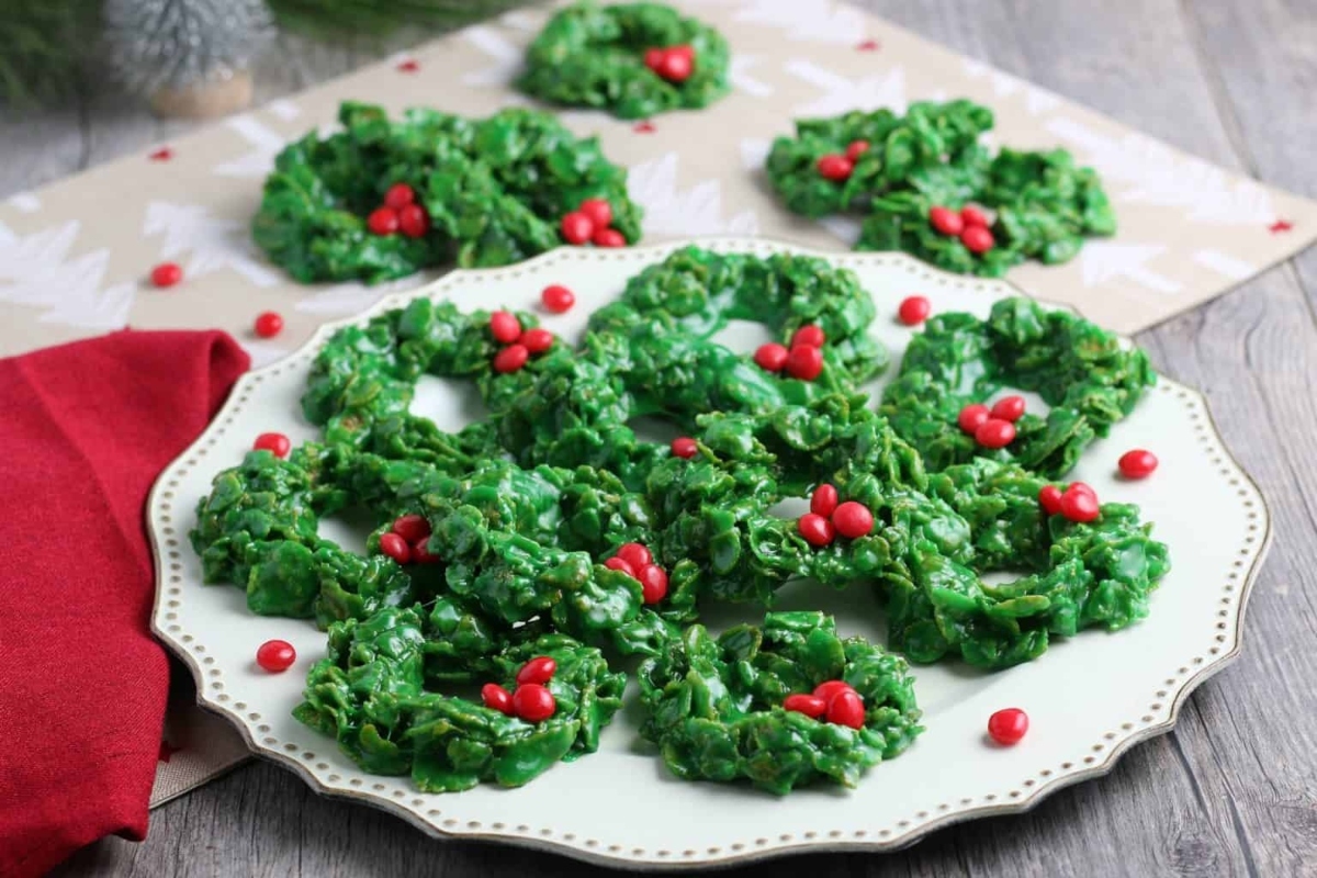 Festive Christmas wreath cookies on a plate.