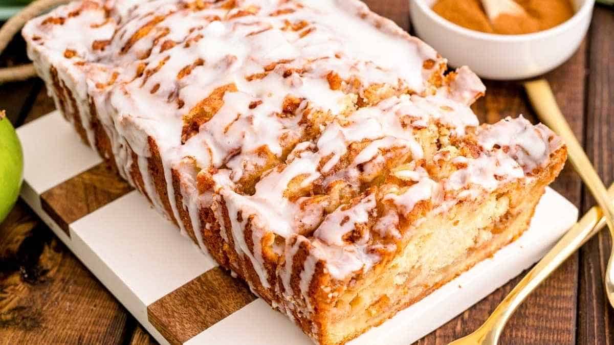 A slice of apple cinnamon bread on a cutting board.