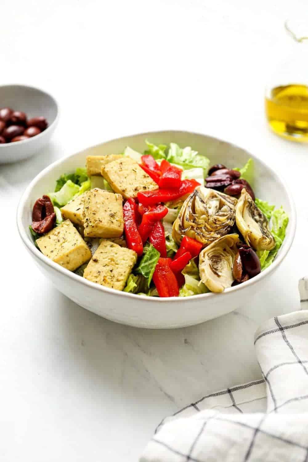 Italian chef salad with kalamata olives, and vegan lemon herb baked tofu. 
