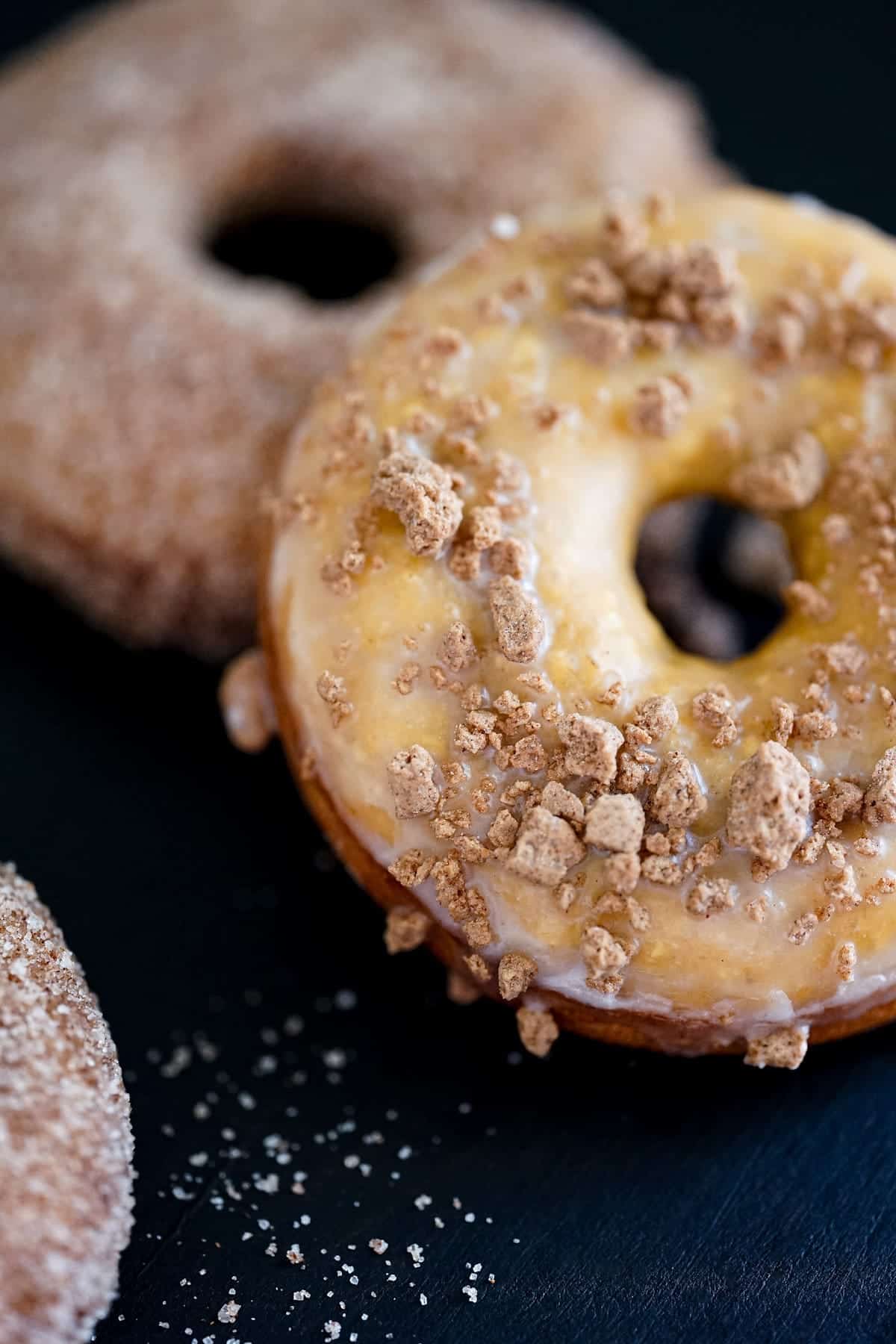 Two unique donuts on a table, each with delicious and distinct flavors.