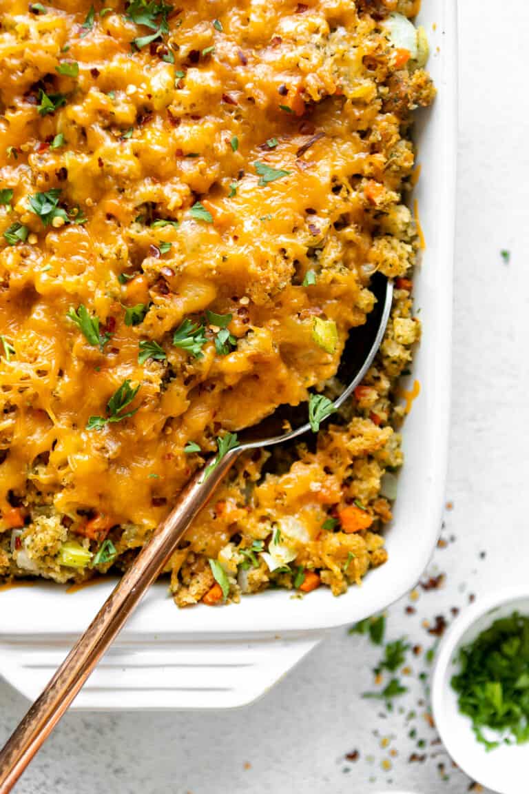 Close up of Chicken Broccoli Stuffing Casserole with a large serving spoon. 
