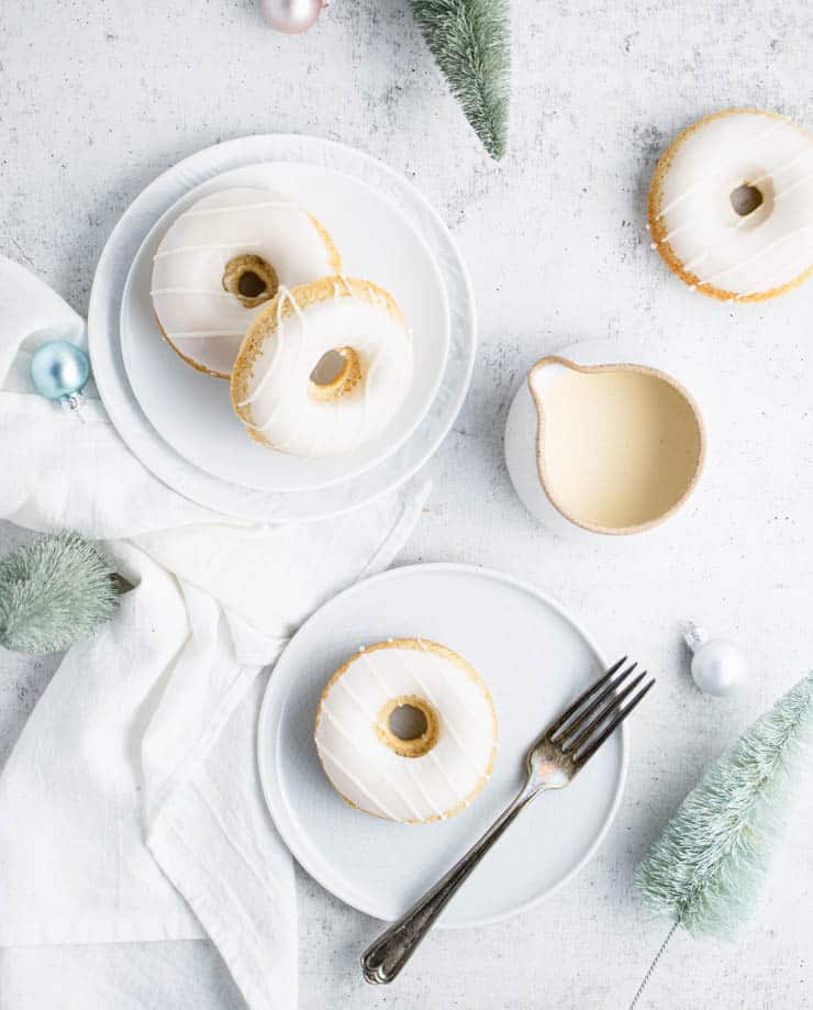 Unique donut flavors on a white plate with icing and a fork.