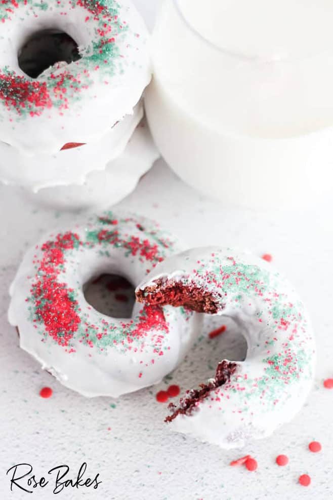 Unique red velvet donuts with sprinkles and milk.