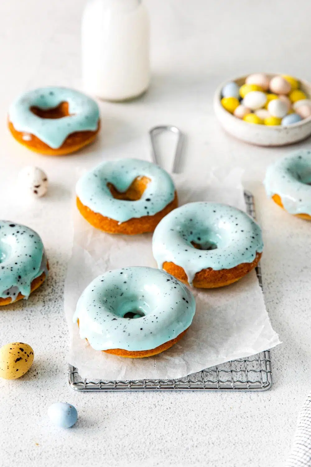 Easter donuts with unique blue icing on a baking sheet.