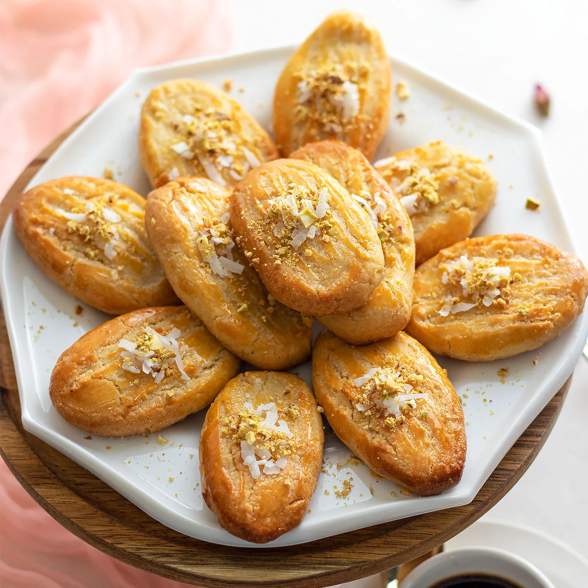 A plate of unique pastries on a table with a cup of coffee.