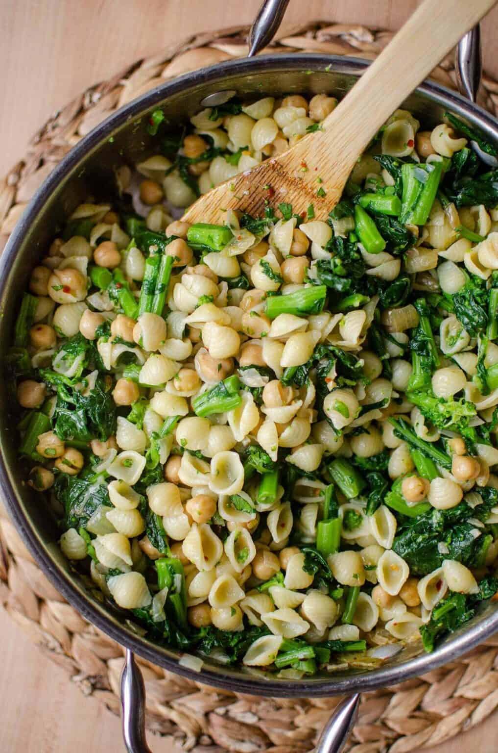 A pot of pasta with a wooden spoon.