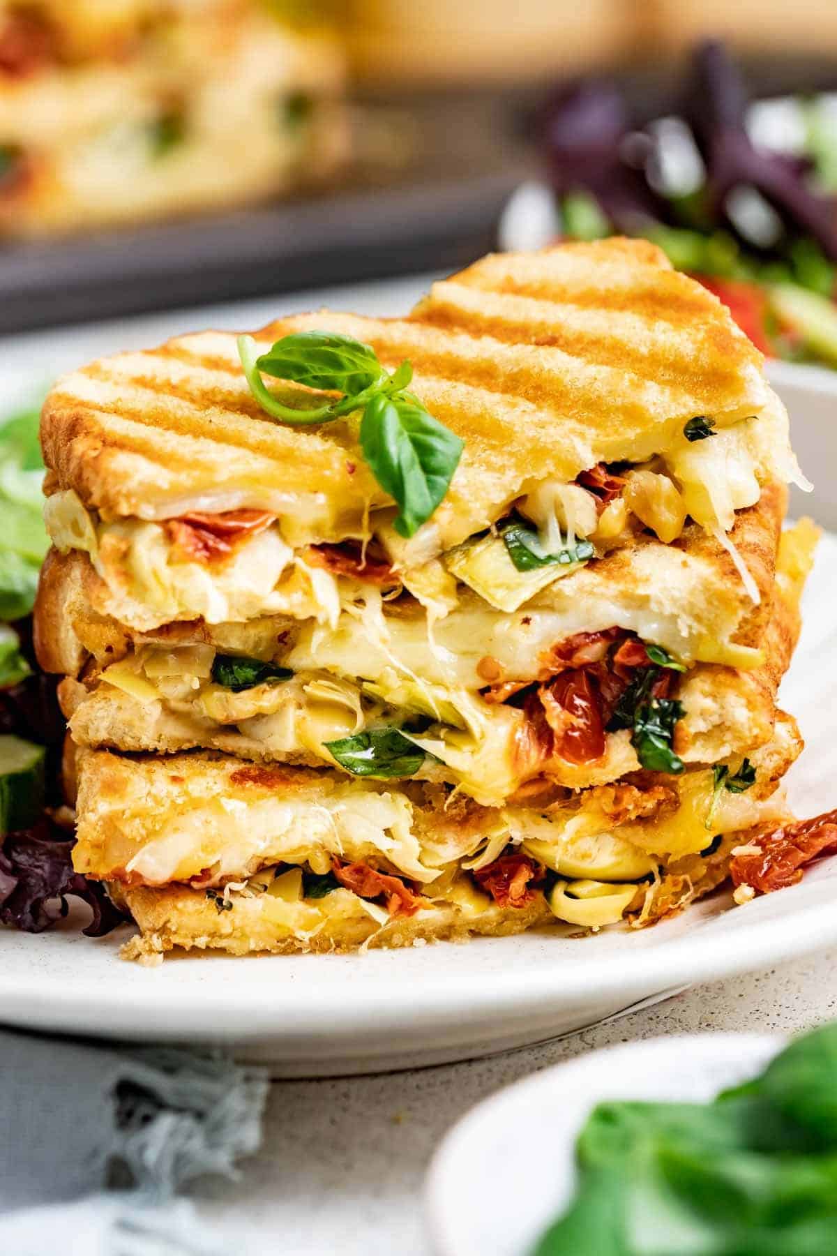 veggie panini cut in half and stacked on top of each other 
