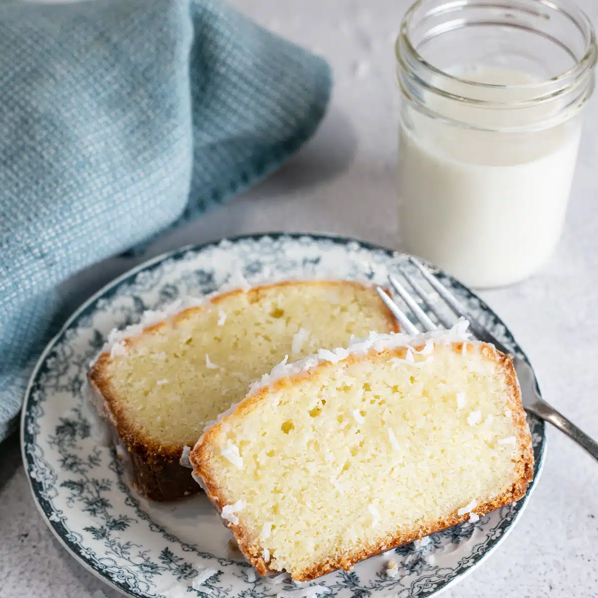 Tender coconut loaf cake is an easy dessert that's holiday worthy for serving up tasty slices like these iced slices. 
