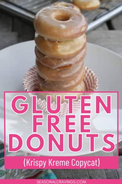 A stack of glazed gluten-free doughnuts sit on a small plate. Text reads "Gluten Free Doughnuts (Krispy Kreme Copycat)" with the source "seasonalcravinging.com" at the bottom.