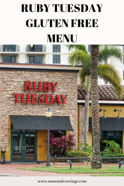 A ruby tuesday restaurant facade with the sign prominently displayed, advertising a gluten free menu, with palm trees in the foreground.