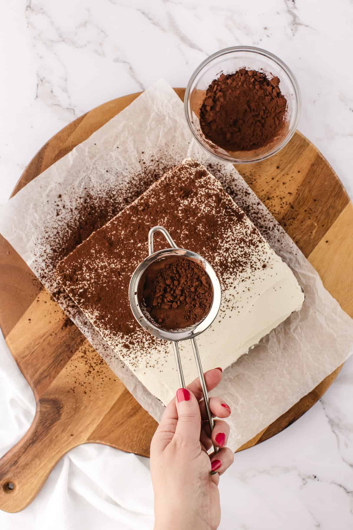 dusting cocoa on brownies